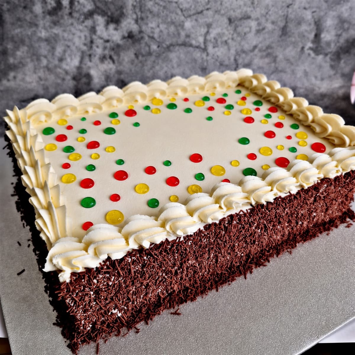 Old-school buttercream birthday cake with colourful piping